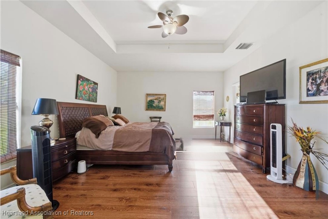 1101 Lakeside Way Sebring, FL 33876 - Photo 10 of 41 a spacious bedroom with a bed and a flat screen tv
