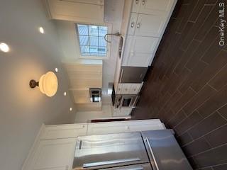 733 East Walnut Street, Unit UPPR Long Beach, NY 11561 - Photo 9 of 26 a kitchen with a sink stainless steel appliances and cabinets