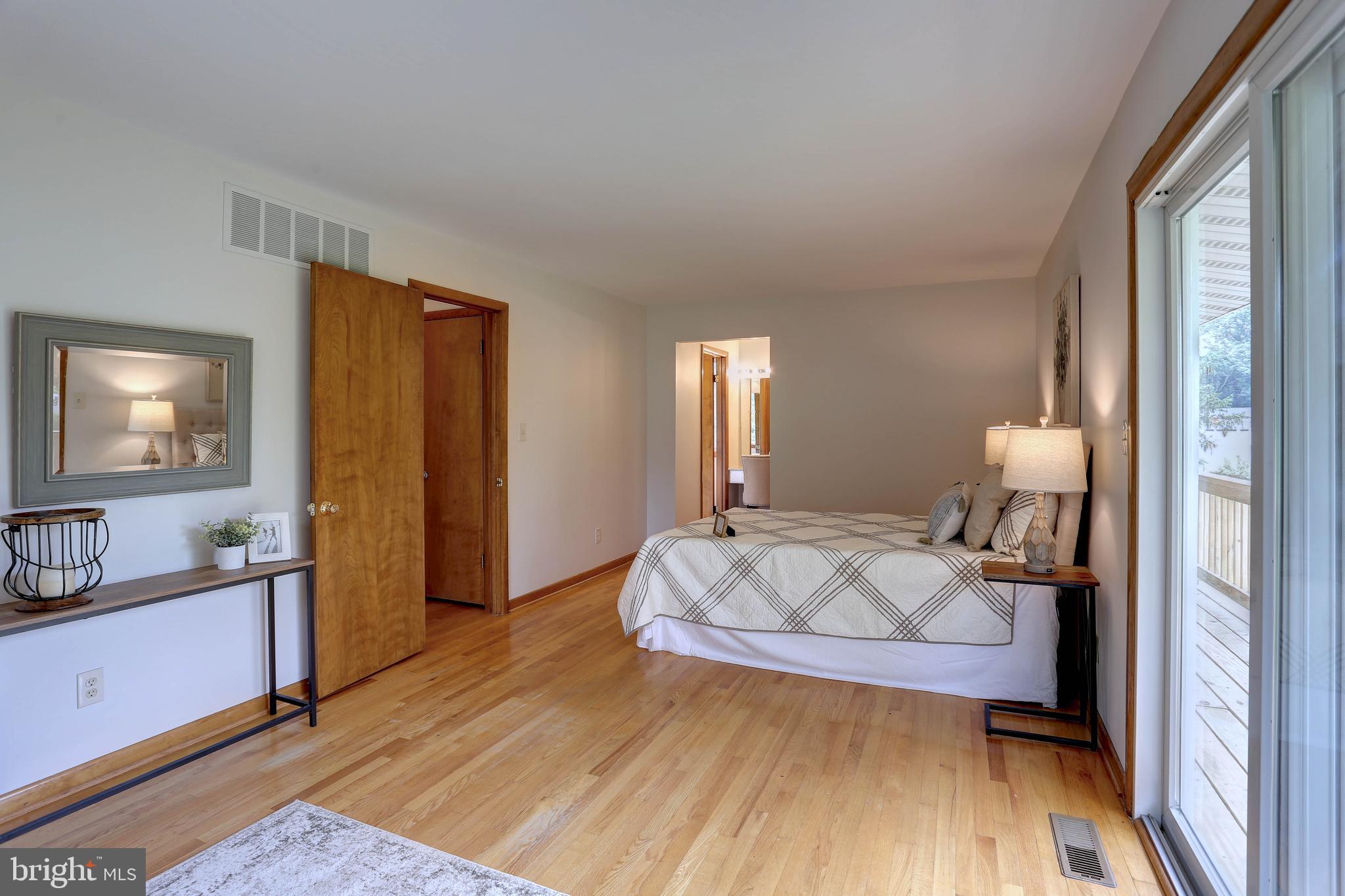 8453 Rolling Ridge Court Ellicott City, MD 21043 - Photo 14 of 39 Primary Bdrm w/ hardwoods,full bath & balcony