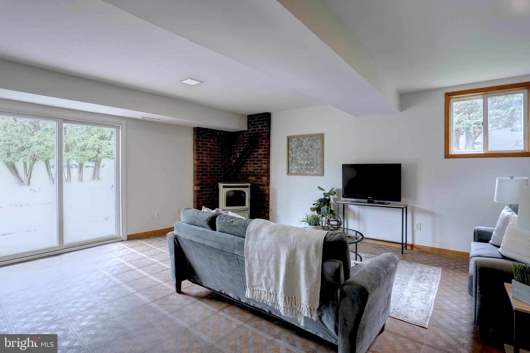 8453 Rolling Ridge Court Ellicott City, MD 21043 - Photo 24 of 39 Lower level family Rm W/Pellet Stove