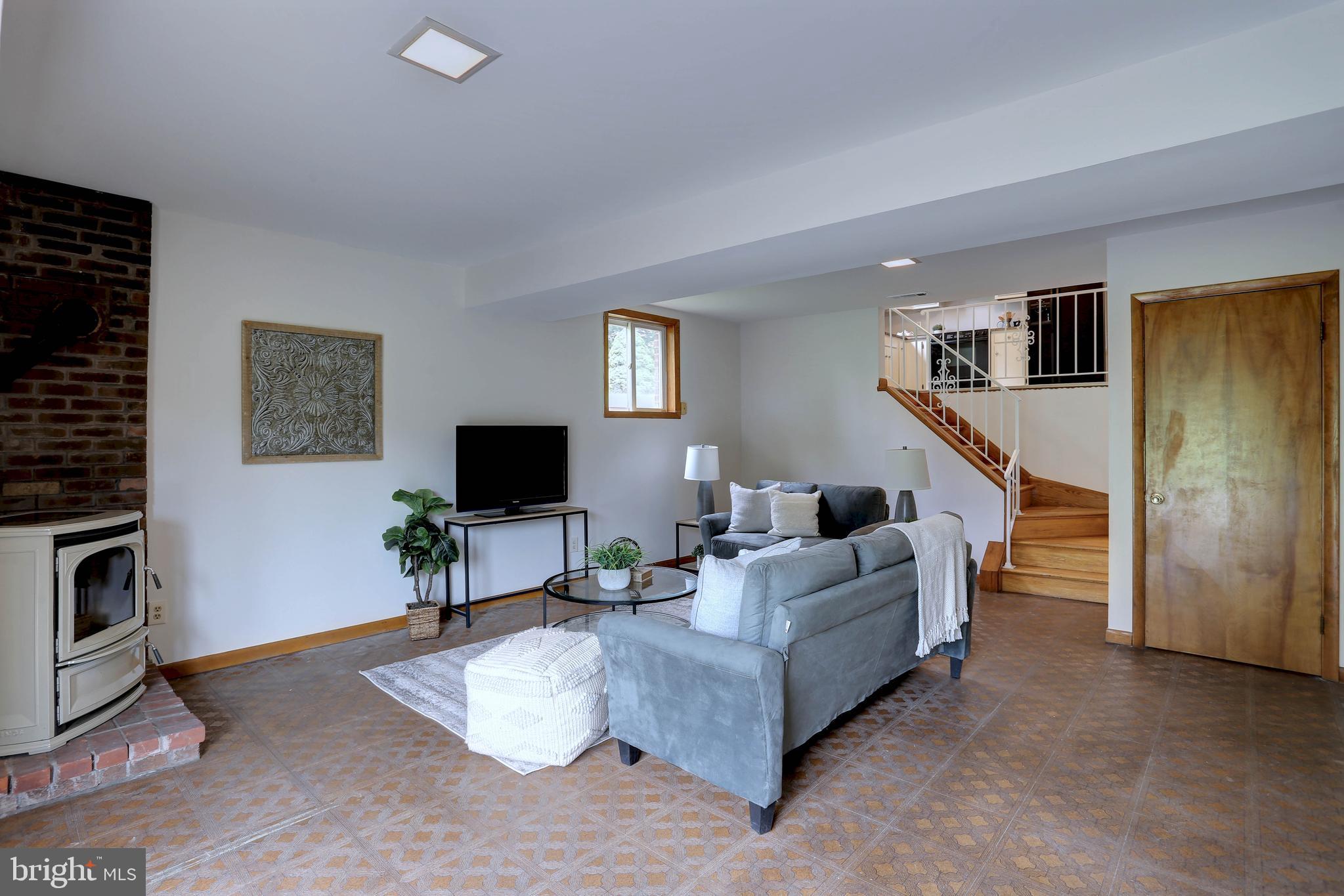 8453 Rolling Ridge Court Ellicott City, MD 21043 - Photo 25 of 39 Lower level family Rm W/Pellet Stove