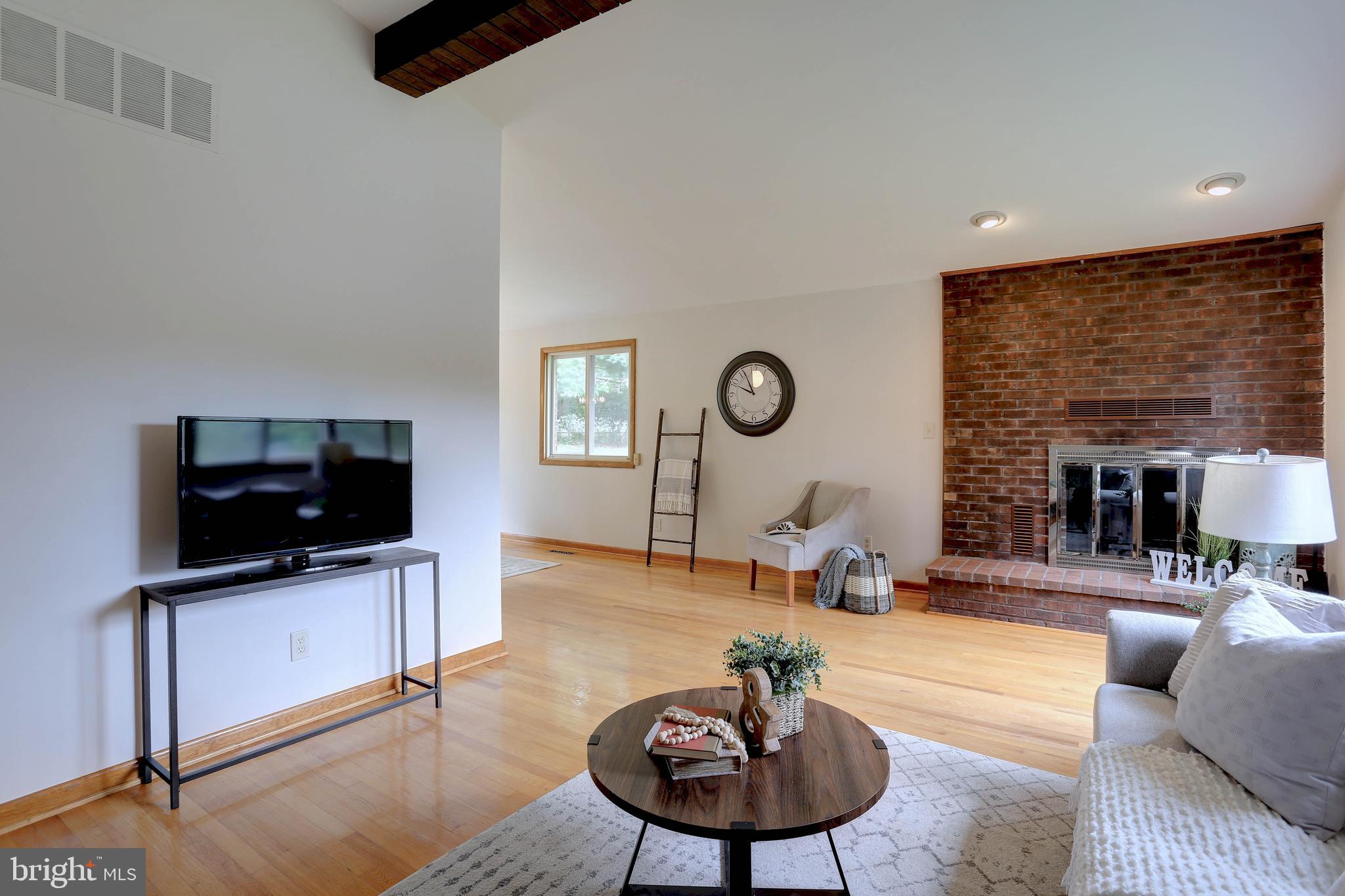 8453 Rolling Ridge Court Ellicott City, MD 21043 - Photo 6 of 39 Living Rm w/wood burning fireplace & hardwood flrs