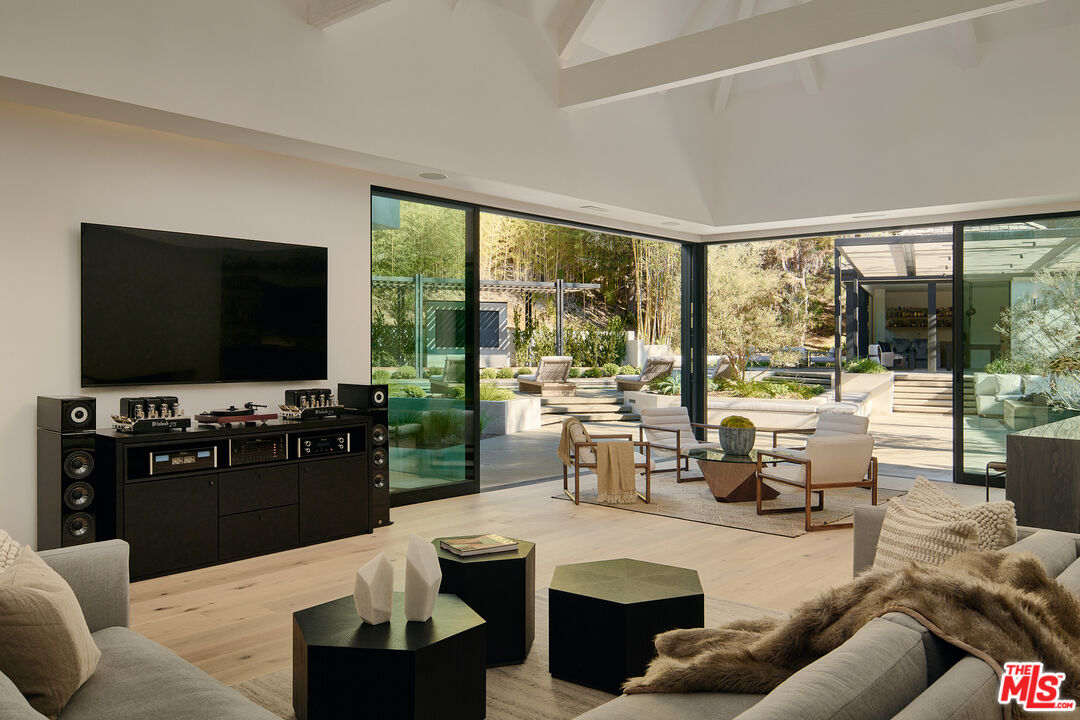 3858 Hayvenhurst Drive Encino, CA 91436 - Photo 15 of 49 a living room with fireplace furniture and a flat screen tv