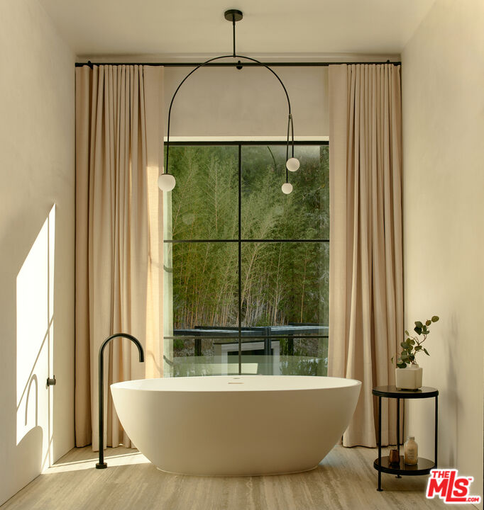 3858 Hayvenhurst Drive Encino, CA 91436 - Photo 28 of 49 a bathroom with a bathtub and a shower