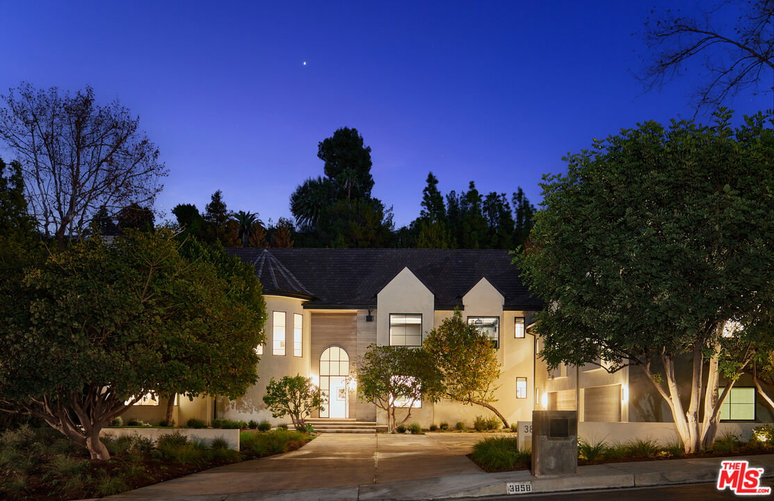 3858 Hayvenhurst Drive Encino, CA 91436 - Photo 49 of 49 a front view of a house with a yard