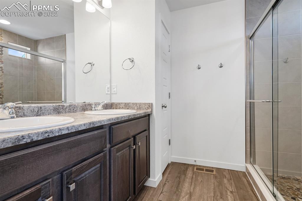 9319 Timberlake Loop Colorado Springs, CO 80927 - Photo 14 of 25 a bathroom with a granite countertop sink and a mirror