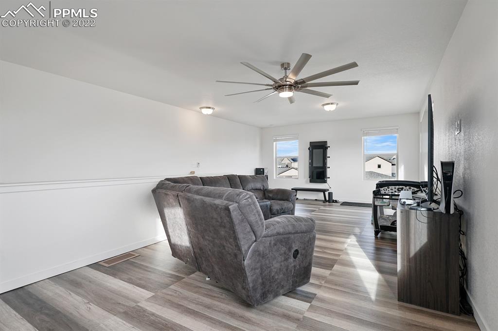 9319 Timberlake Loop Colorado Springs, CO 80927 - Photo 20 of 25 a living room with furniture and a wooden floor