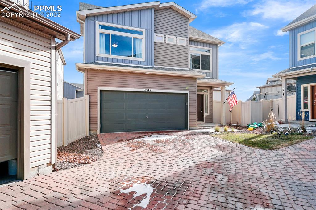 9319 Timberlake Loop Colorado Springs, CO 80927 - Photo 2 of 25 a front view of a house with a yard