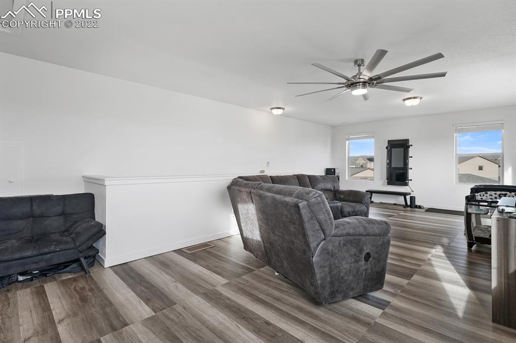 9319 Timberlake Loop Colorado Springs, CO 80927 - Photo 21 of 25 a living room with couches and furniture with wooden floor