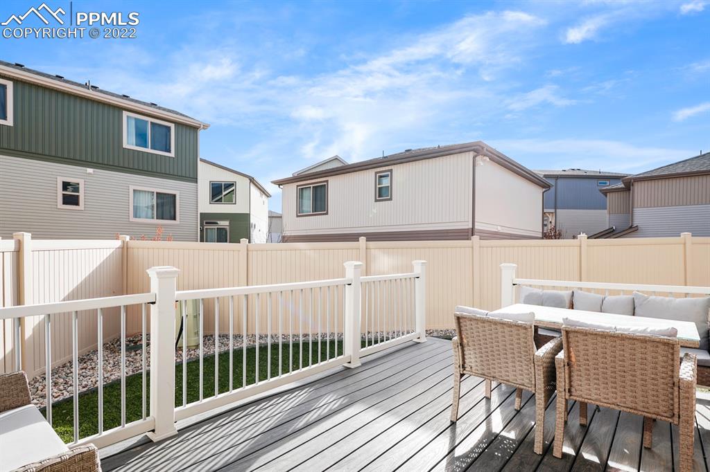 9319 Timberlake Loop Colorado Springs, CO 80927 - Photo 23 of 25 a view of a house with wooden deck and furniture