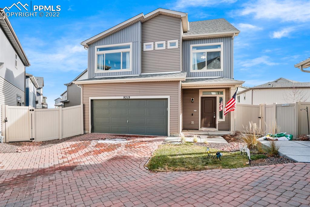 9319 Timberlake Loop Colorado Springs, CO 80927 - Photo 3 of 25 a front view of a house with a yard