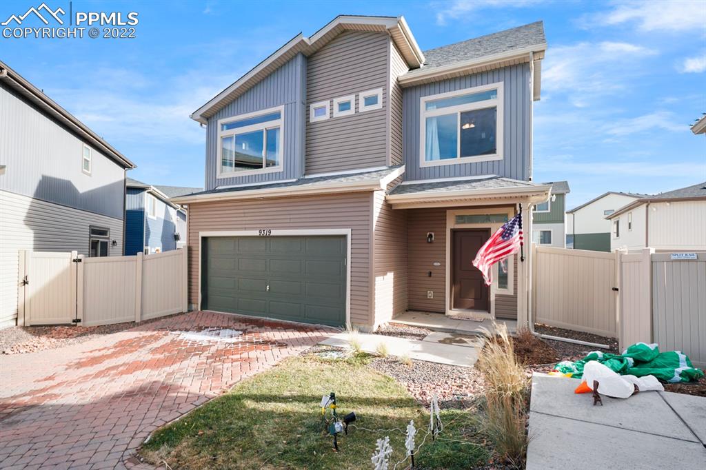 9319 Timberlake Loop Colorado Springs, CO 80927 - Photo 4 of 25 a front view of a house with a garage