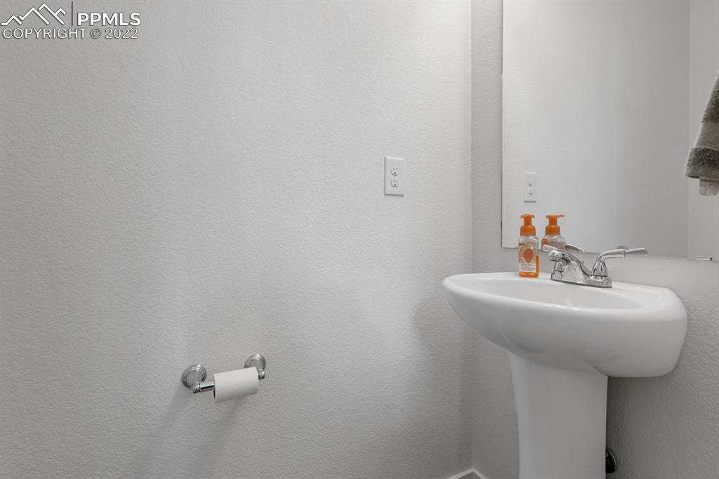 9319 Timberlake Loop Colorado Springs, CO 80927 - Photo 6 of 25 a bathroom with a sink and mirror