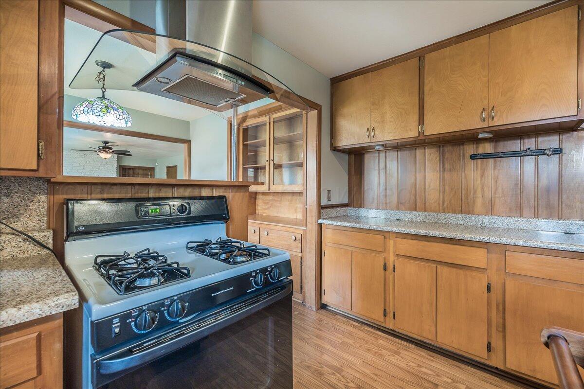 3017 Mockingbird Lane Amarillo, TX 79109 - Photo 11 of 25 a kitchen with granite countertop a stove and a sink
