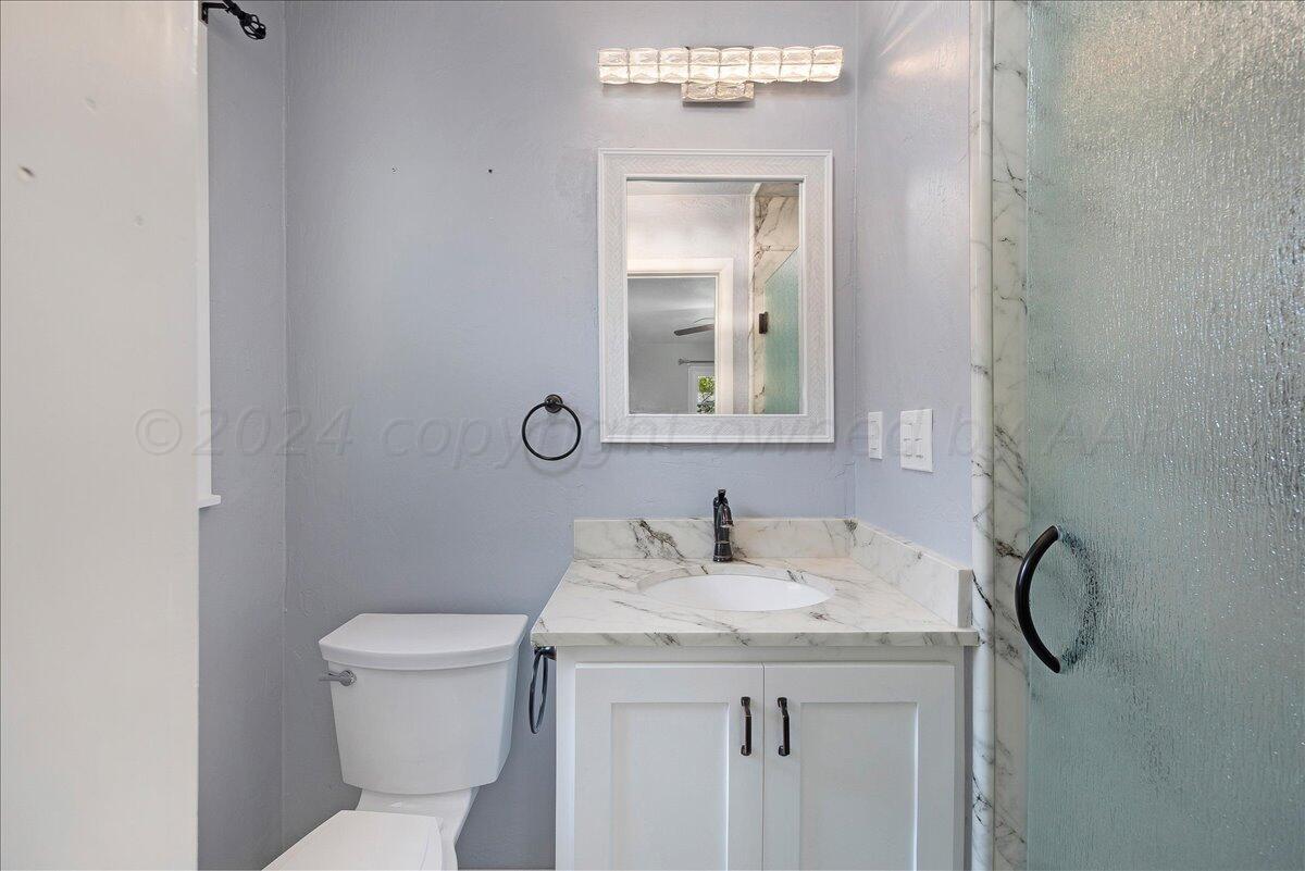 3017 Mockingbird Lane Amarillo, TX 79109 - Photo 16 of 25 a bathroom with a sink toilet and mirror