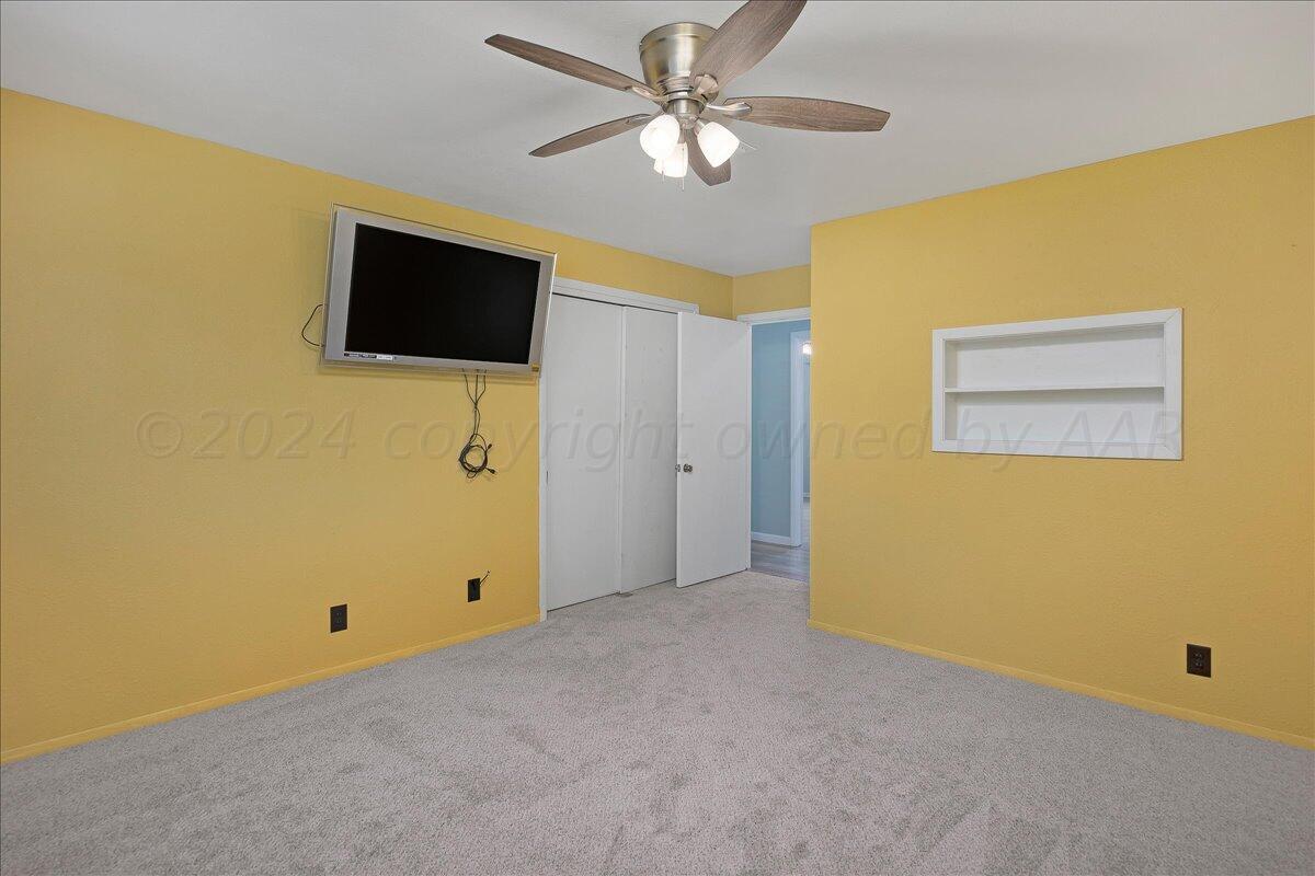 3017 Mockingbird Lane Amarillo, TX 79109 - Photo 22 of 25 a view of a livingroom with an empty space and a ceiling fan