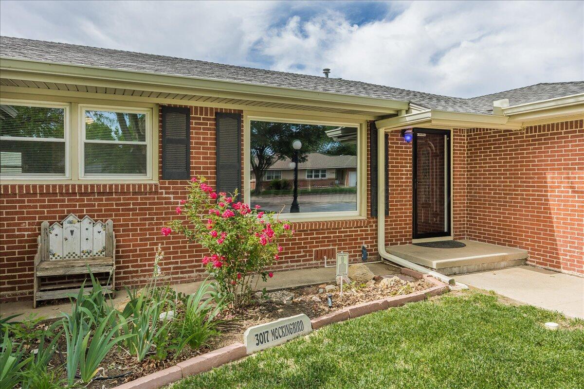 3017 Mockingbird Lane Amarillo, TX 79109 - Photo 3 of 25 a front view of a house with a garden