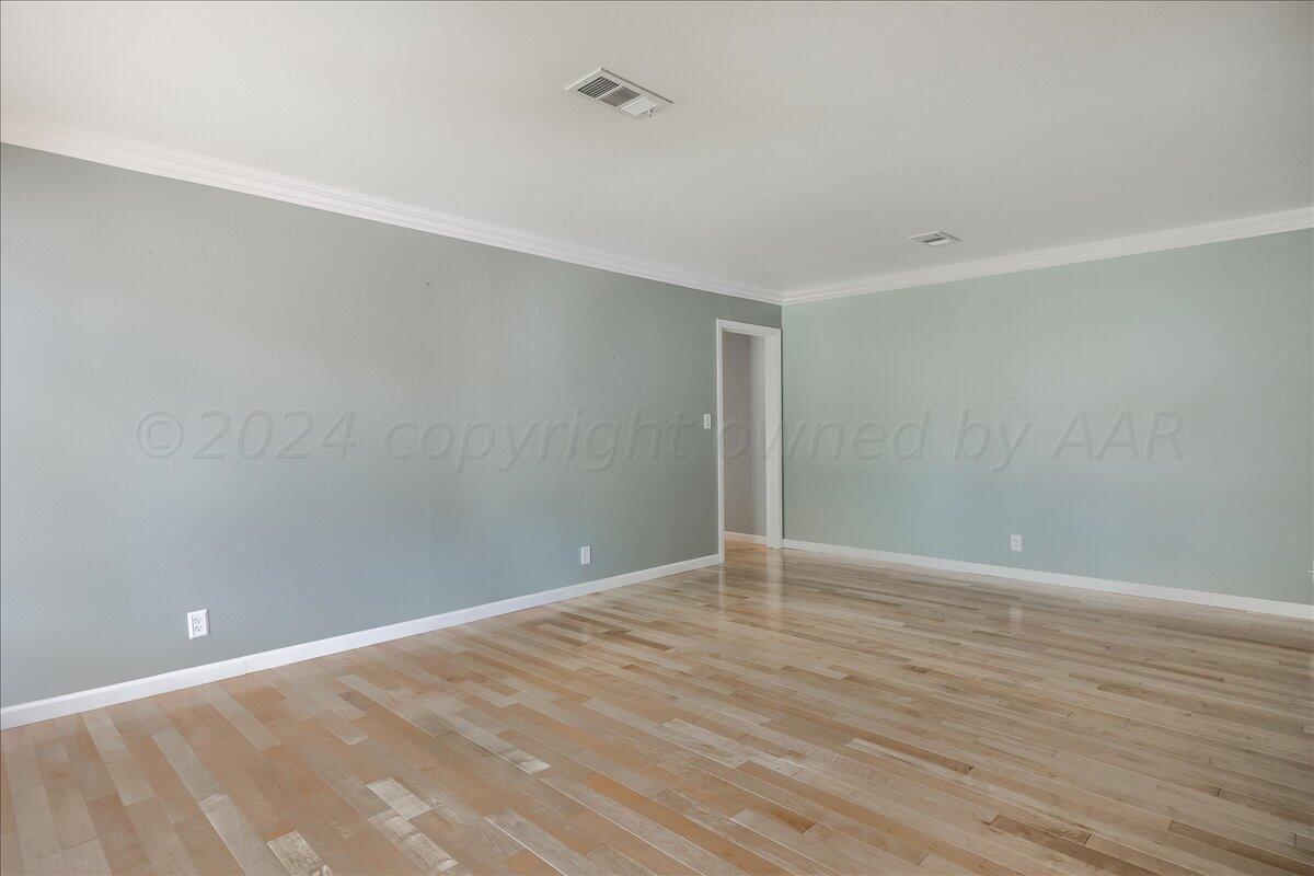3017 Mockingbird Lane Amarillo, TX 79109 - Photo 5 of 25 a view of an empty room with wooden floor