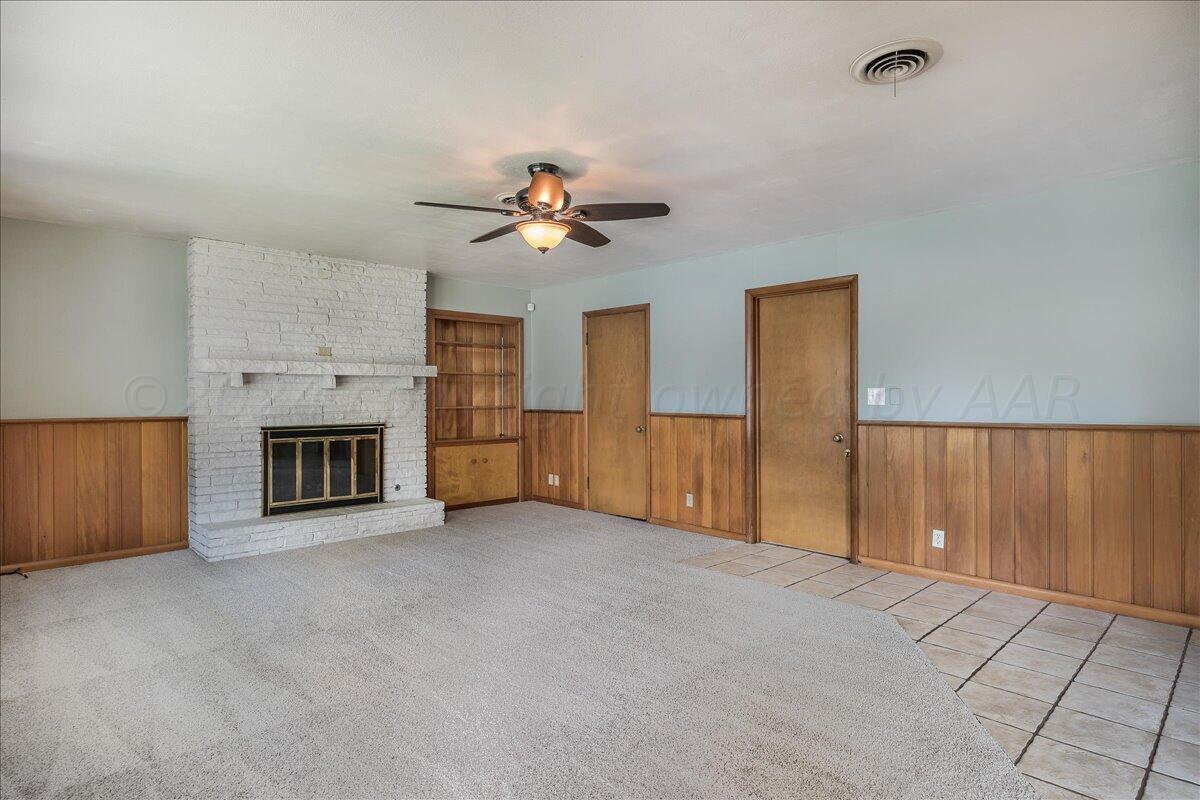 3017 Mockingbird Lane Amarillo, TX 79109 - Photo 7 of 25 a view of a livingroom with a fireplace and a chandelier fan