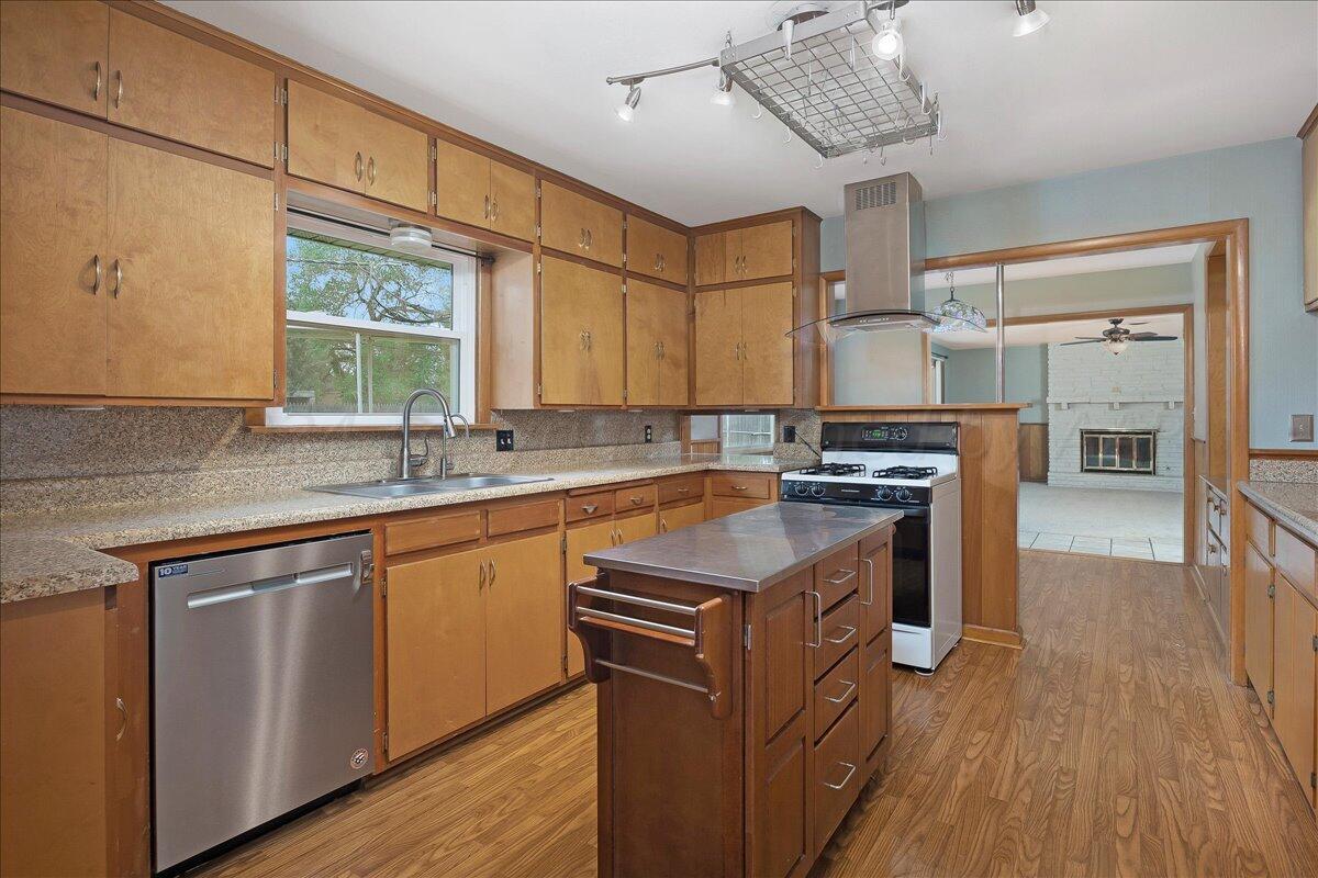 3017 Mockingbird Lane Amarillo, TX 79109 - Photo 9 of 25 a kitchen with stainless steel appliances granite countertop a lot of counter space and wooden floors