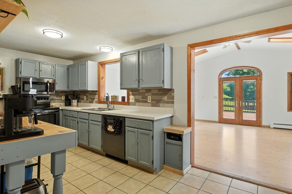 4 Dunhamtown Road Monson, MA 01069 - Photo 6 of 27 a kitchen with stainless steel appliances granite countertop a stove a sink and a refrigerator