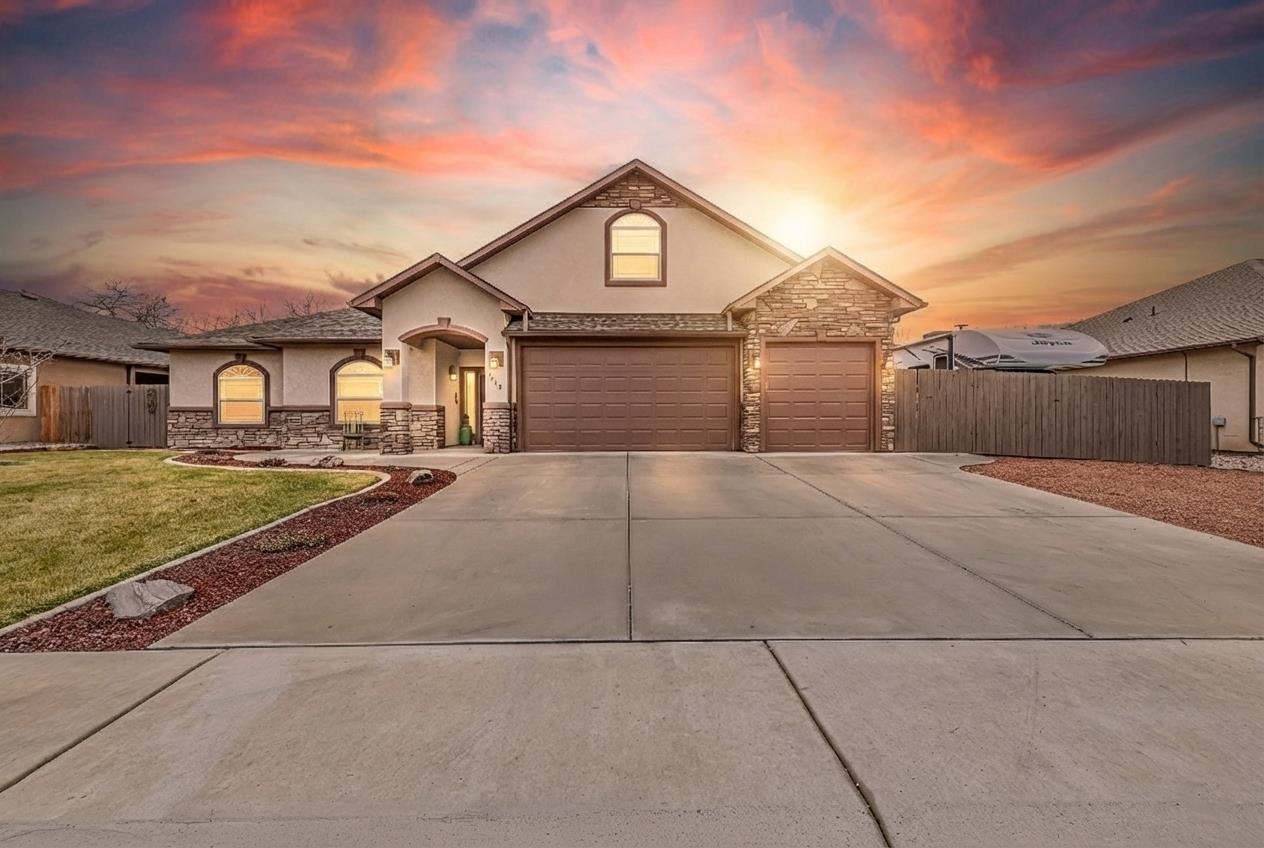 1660 Powis Lane Fruita, CO 81521 - Photo 1 of 38 a front view of a house with a yard
