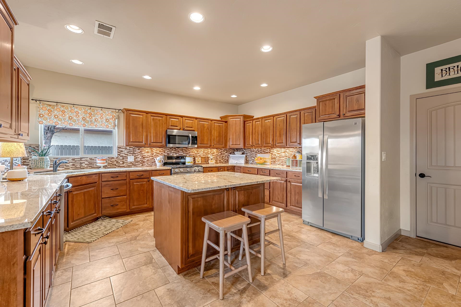 1660 Powis Lane Fruita, CO 81521 - Photo 11 of 38 a kitchen with stainless steel appliances granite countertop a stove a sink a refrigerator and a refrigerator
