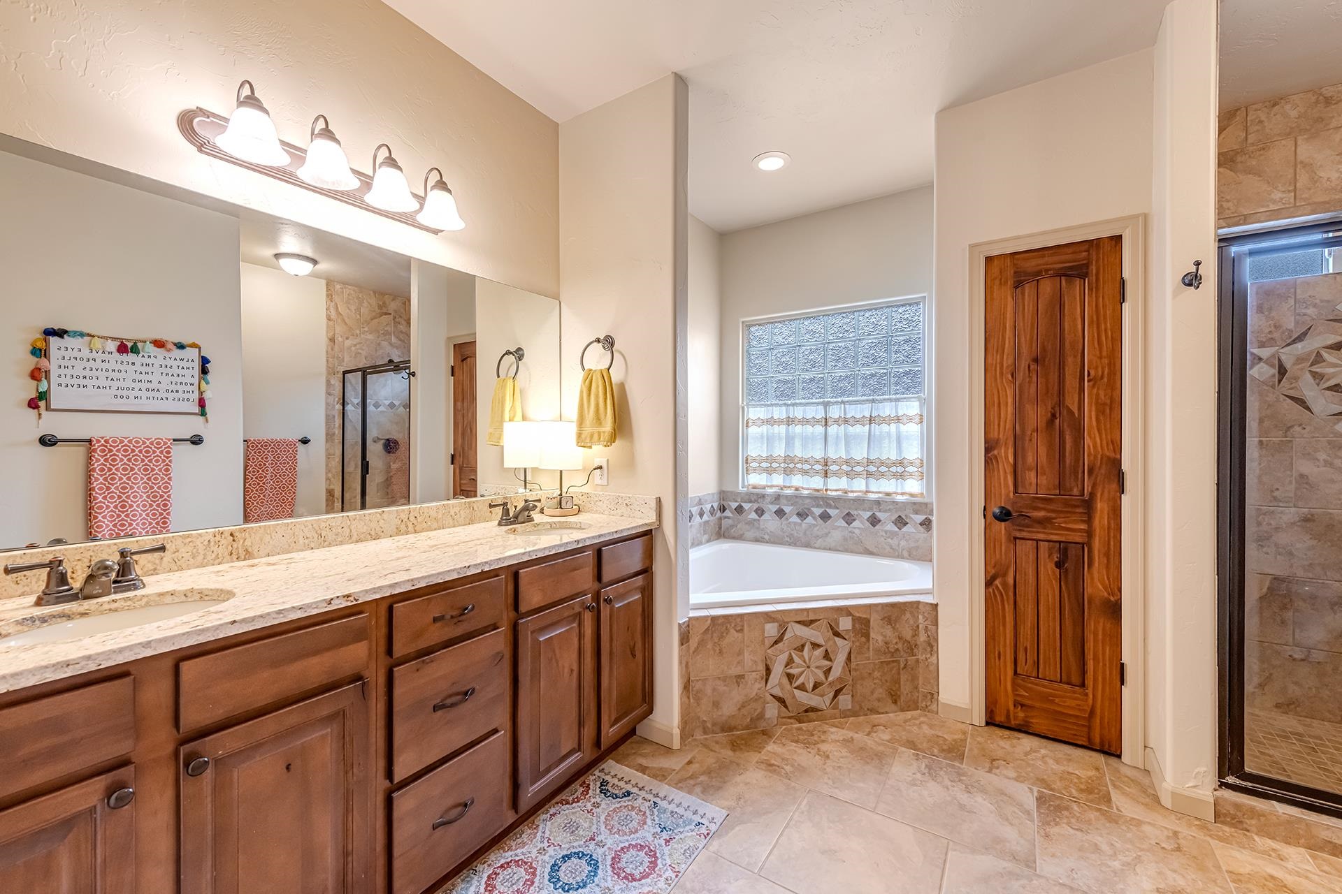 1660 Powis Lane Fruita, CO 81521 - Photo 15 of 38 a spacious bathroom with a double vanity sink mirror and bathtub
