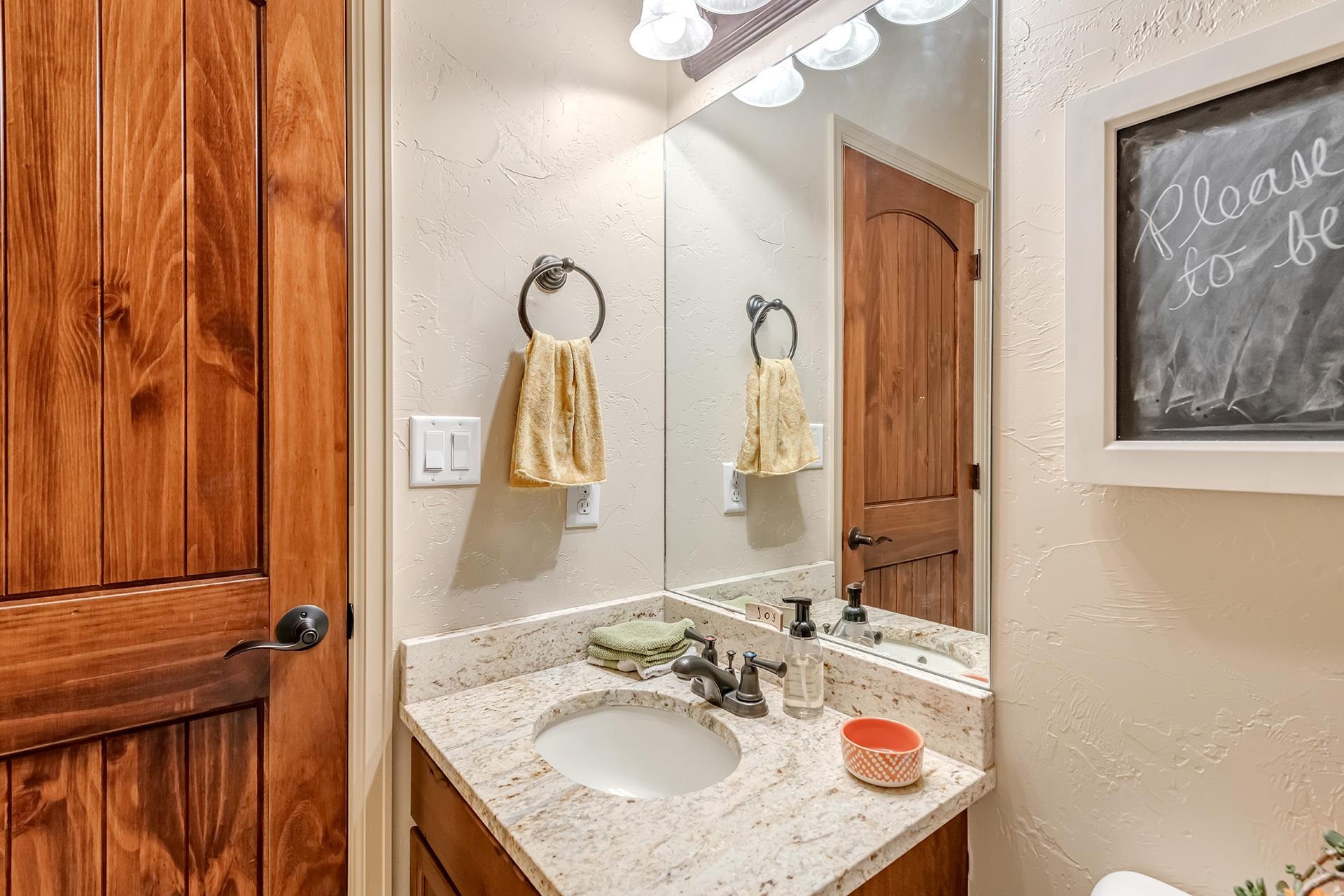 1660 Powis Lane Fruita, CO 81521 - Photo 18 of 38 a bathroom with a granite countertop sink and a mirror