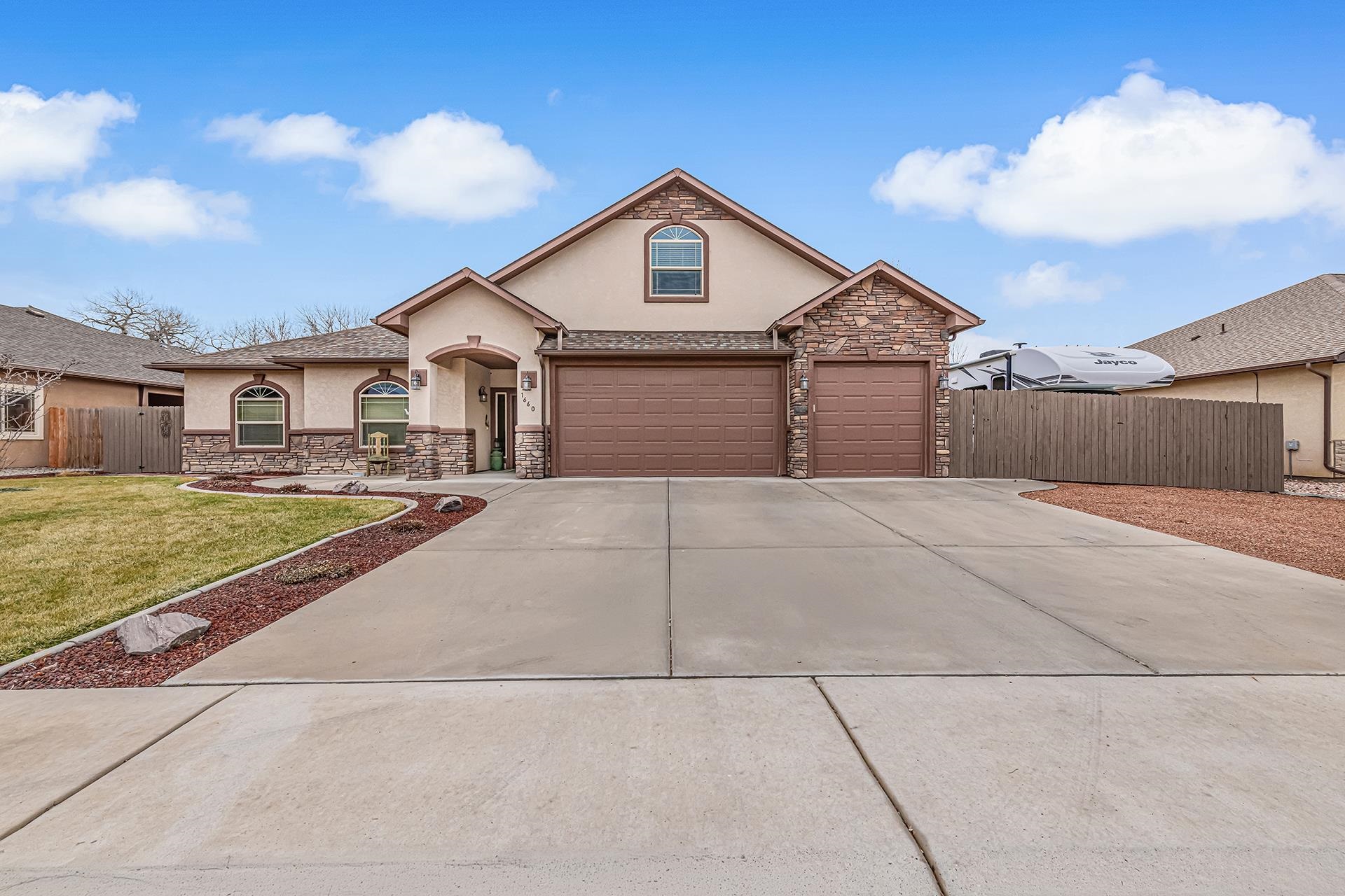 1660 Powis Lane Fruita, CO 81521 - Photo 2 of 38 a front view of a house with a yard
