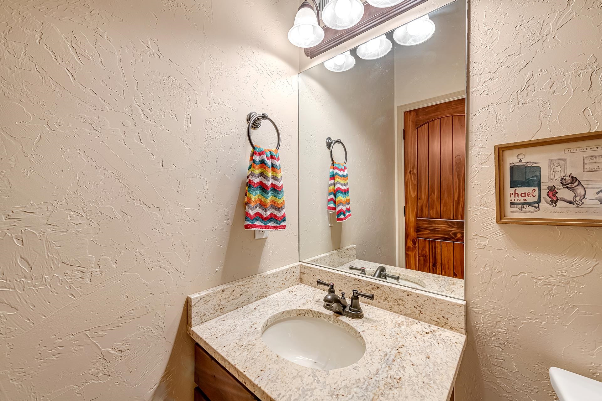 1660 Powis Lane Fruita, CO 81521 - Photo 22 of 38 a bathroom with a granite countertop sink and a mirror