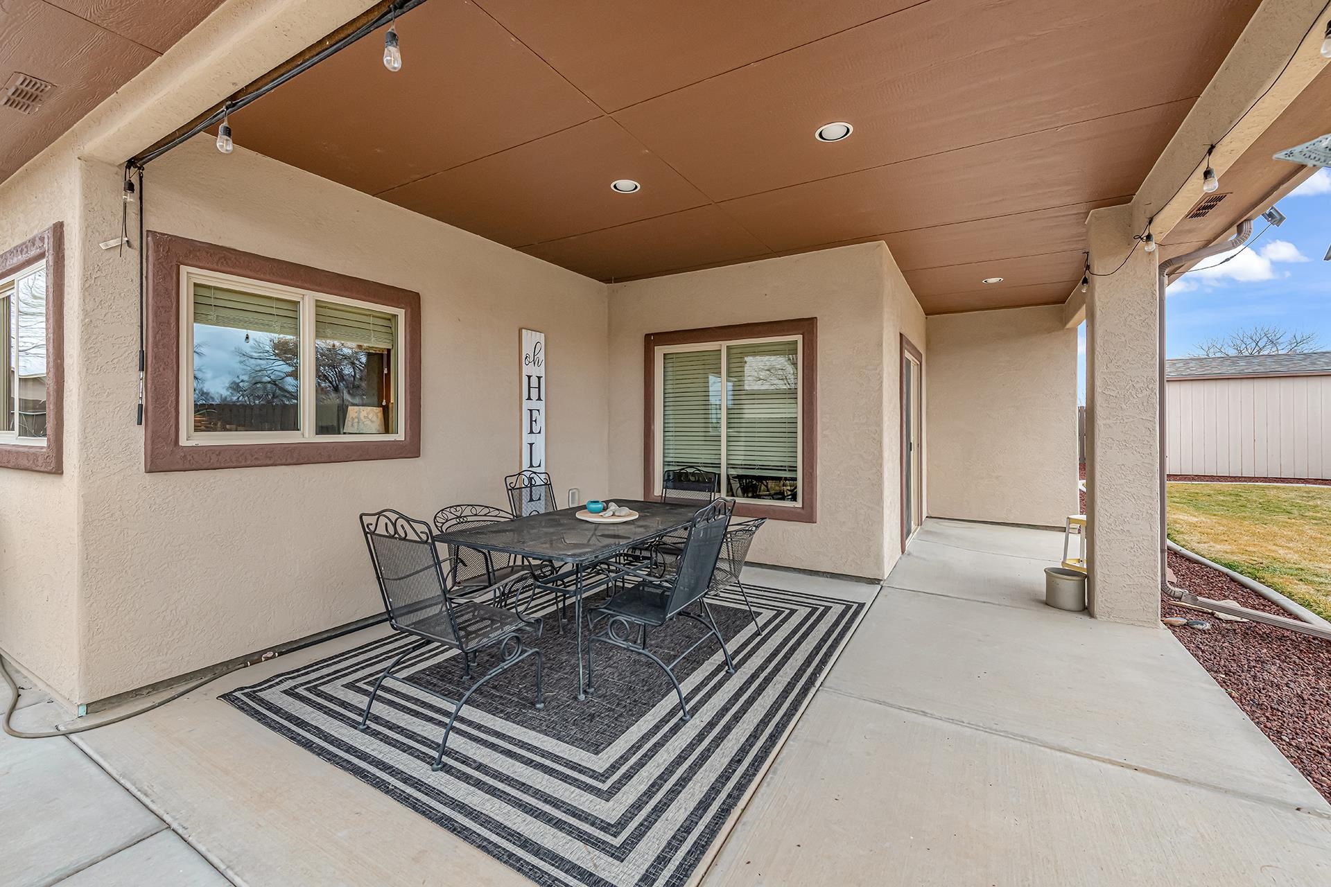 1660 Powis Lane Fruita, CO 81521 - Photo 26 of 38 a living room with furniture a large window and wooden floor