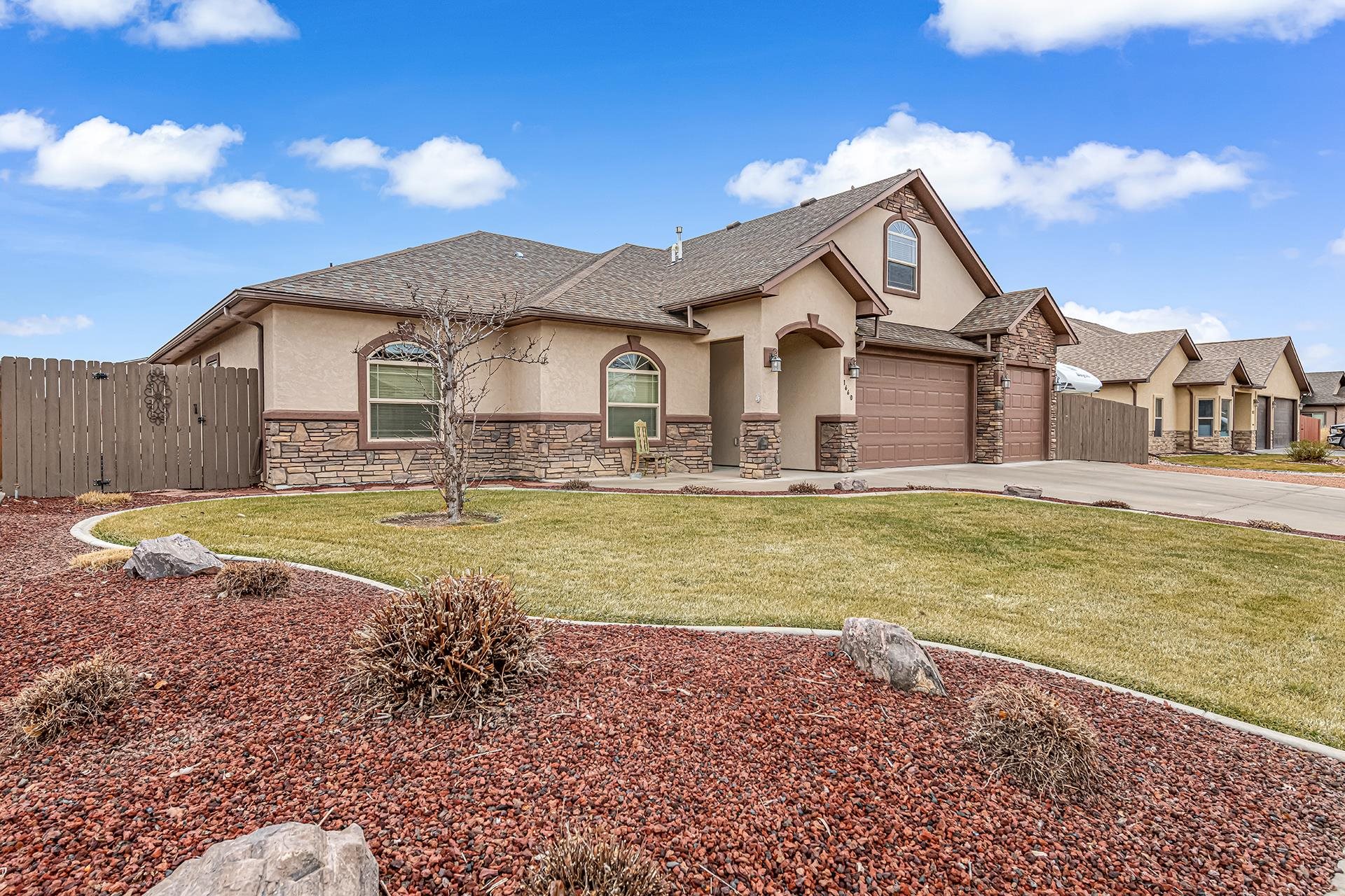 1660 Powis Lane Fruita, CO 81521 - Photo 4 of 38 a view of a house with a big yard and large trees