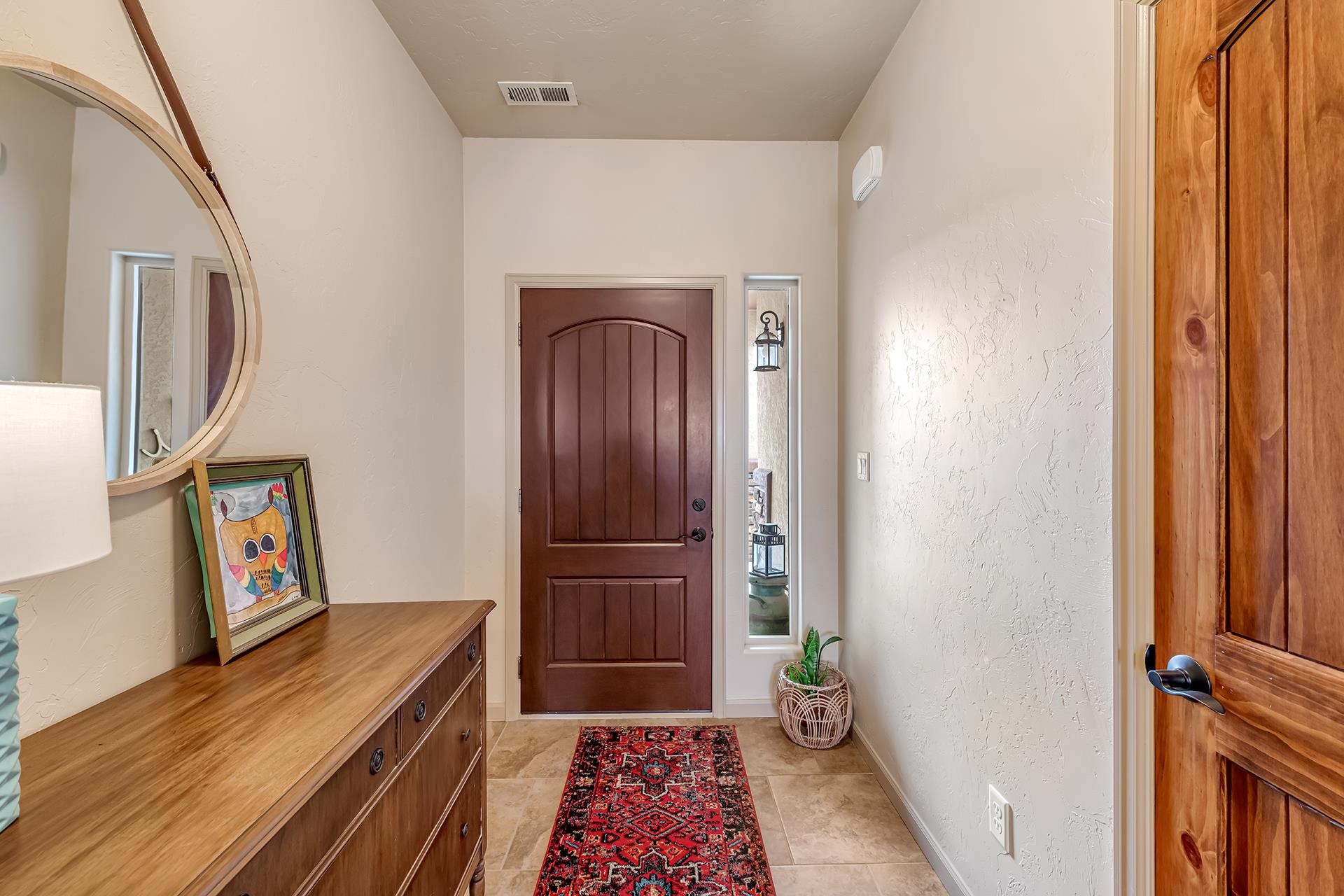 1660 Powis Lane Fruita, CO 81521 - Photo 7 of 38 a view of a hallway with wooden floor and a livingroom