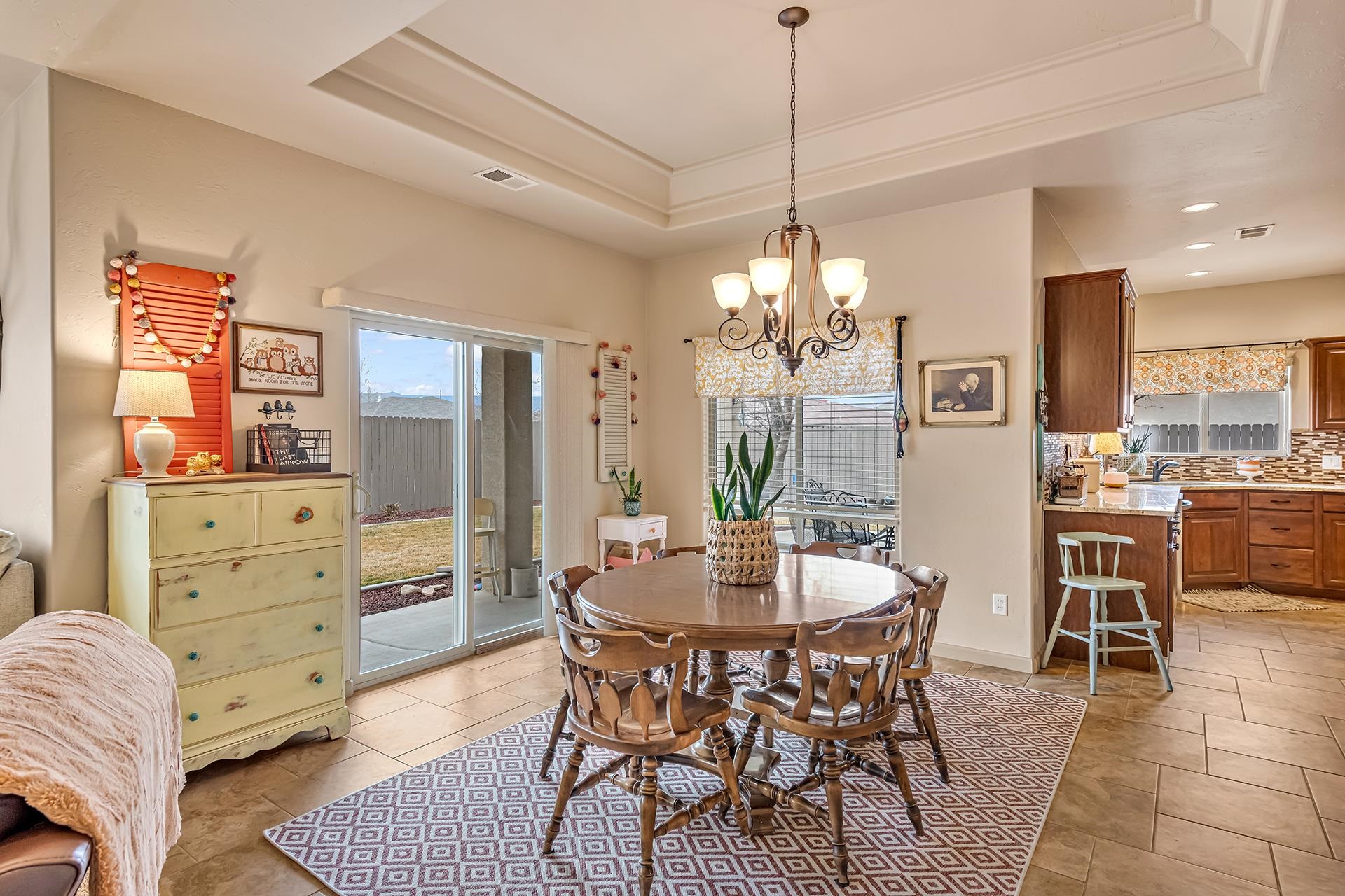 1660 Powis Lane Fruita, CO 81521 - Photo 10 of 38 a dining room with furniture a chandelier and window