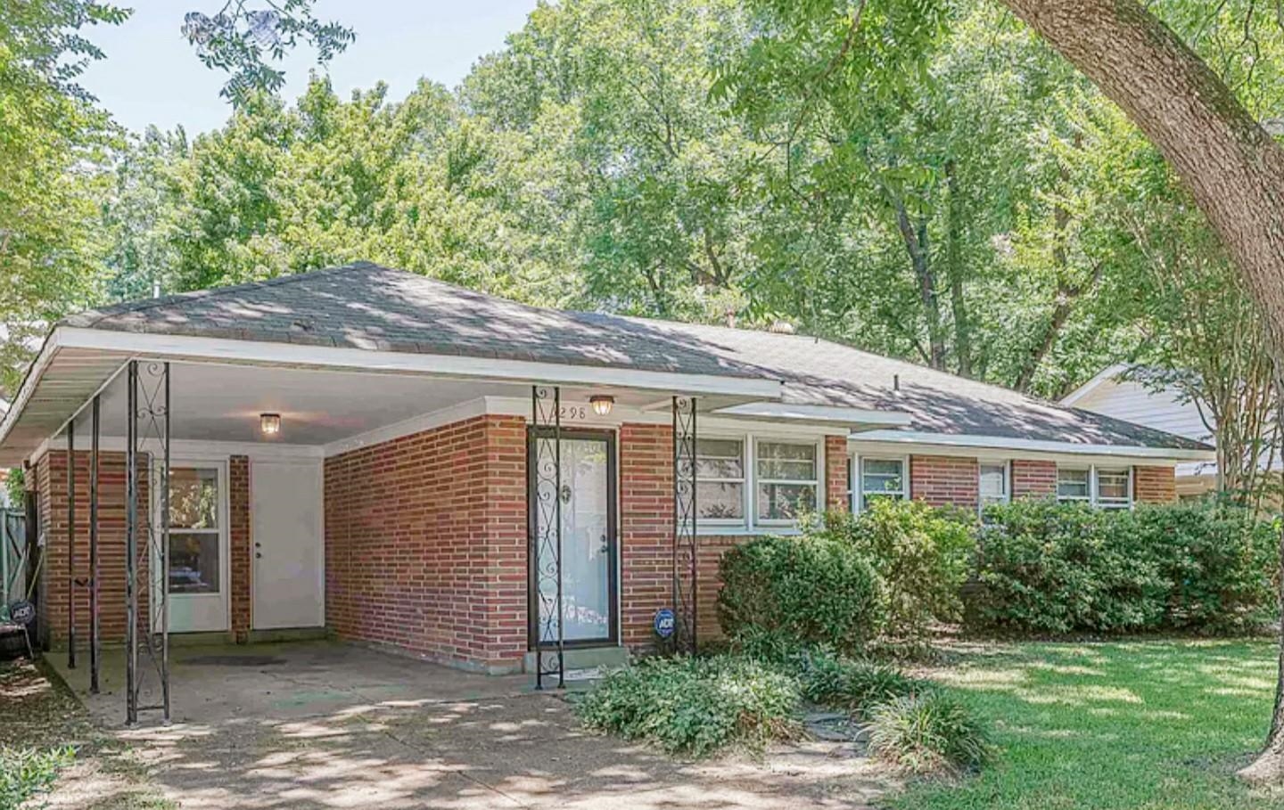 5298 Mesquite Road Memphis, TN 38120 - Photo 2 of 20 a backyard of a house with plants and tree