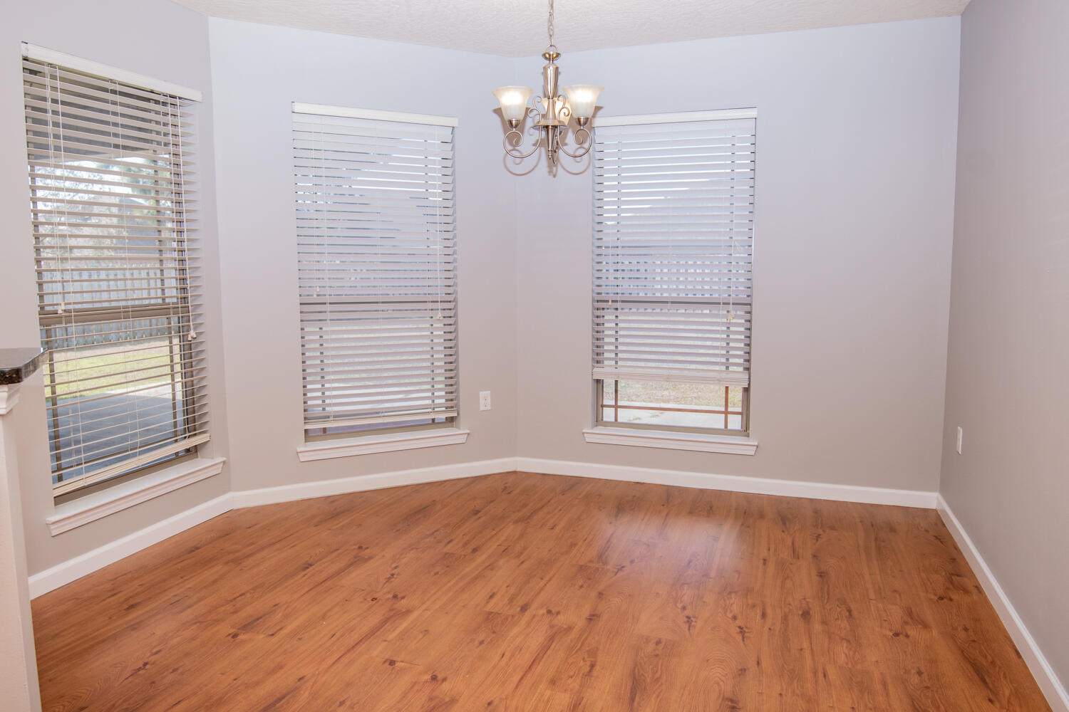 5265 Moore Loop Crestview, FL 32536 - Photo 11 of 25 a view of an empty room with wooden floor and a window