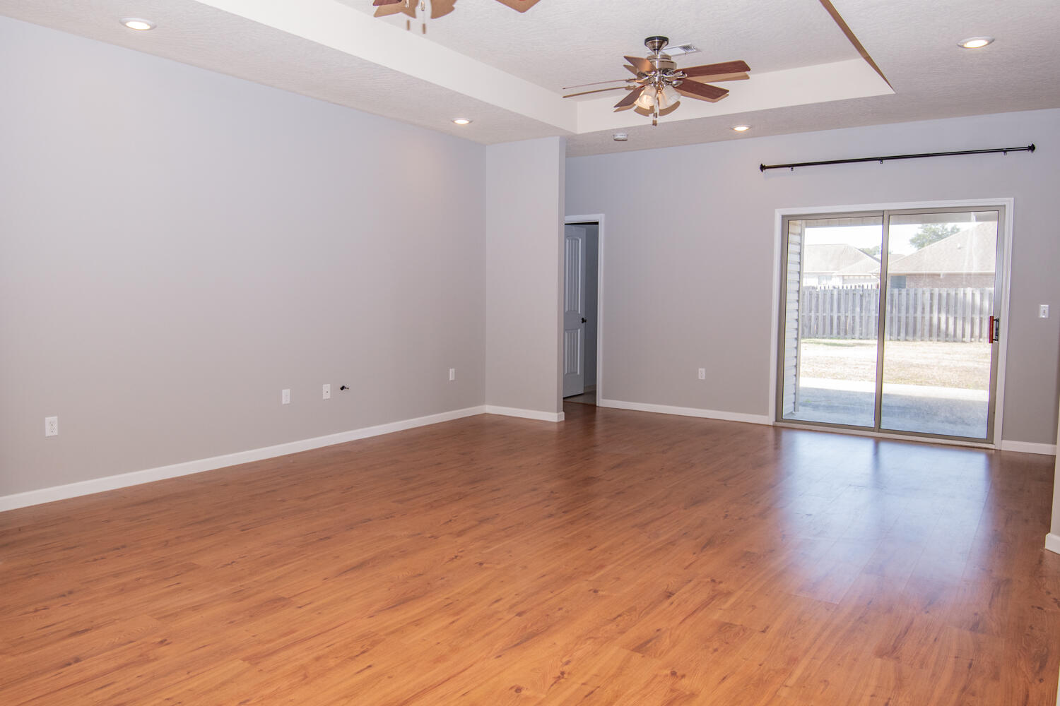 5265 Moore Loop Crestview, FL 32536 - Photo 3 of 25 wooden floor in an empty room with a window