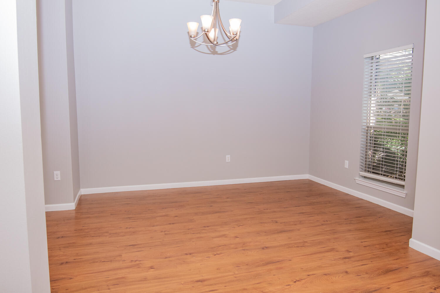 5265 Moore Loop Crestview, FL 32536 - Photo 5 of 25 a view of an empty room with wooden floor and a window