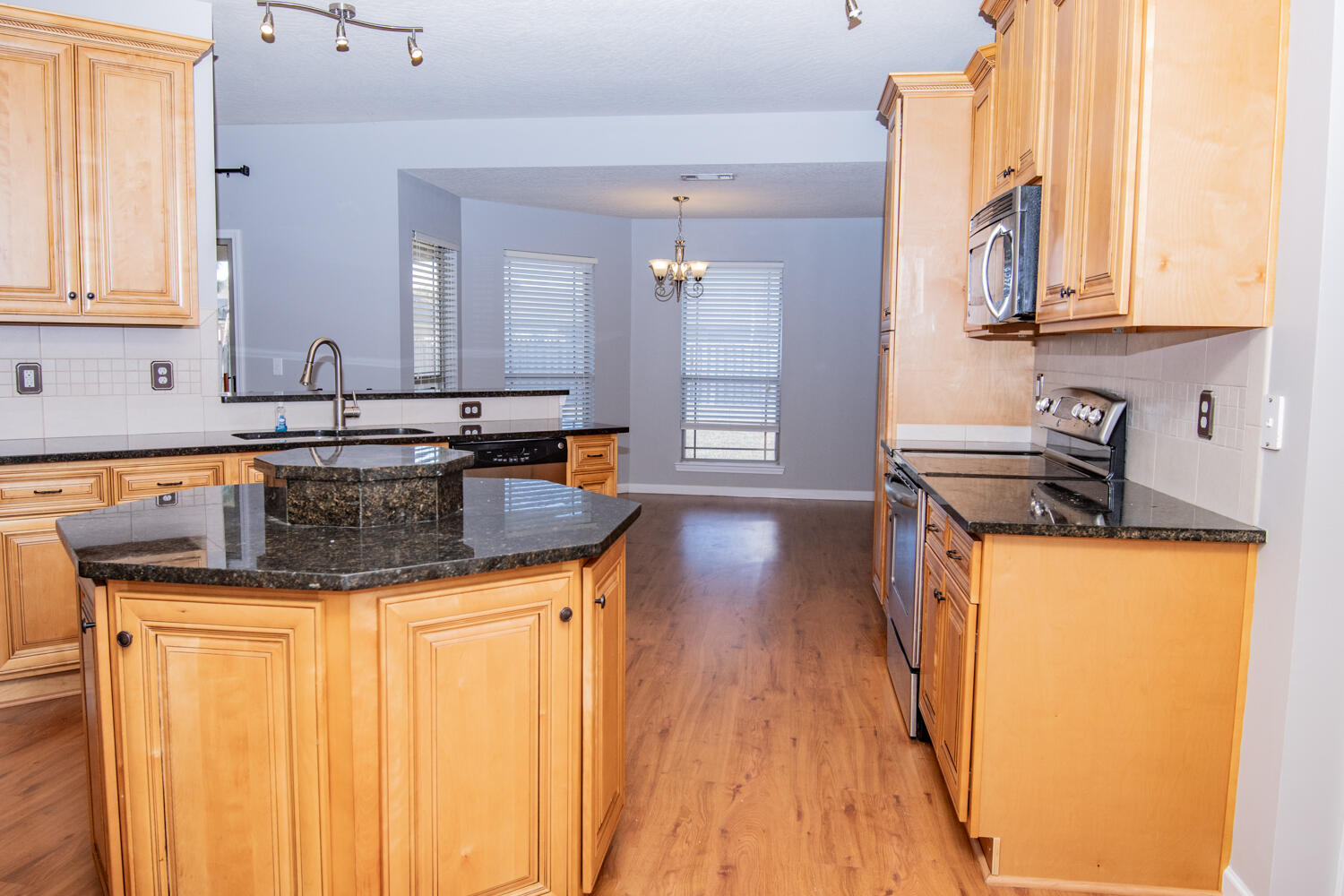 5265 Moore Loop Crestview, FL 32536 - Photo 8 of 25 a kitchen with stainless steel appliances granite countertop a sink a stove and cabinets