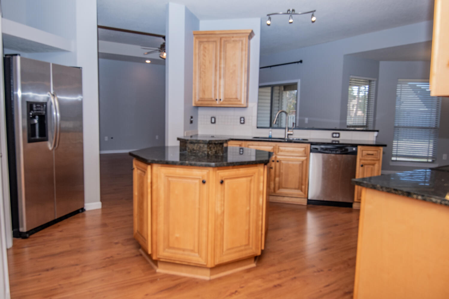 5265 Moore Loop Crestview, FL 32536 - Photo 10 of 25 a kitchen with granite countertop a refrigerator and a stove top oven