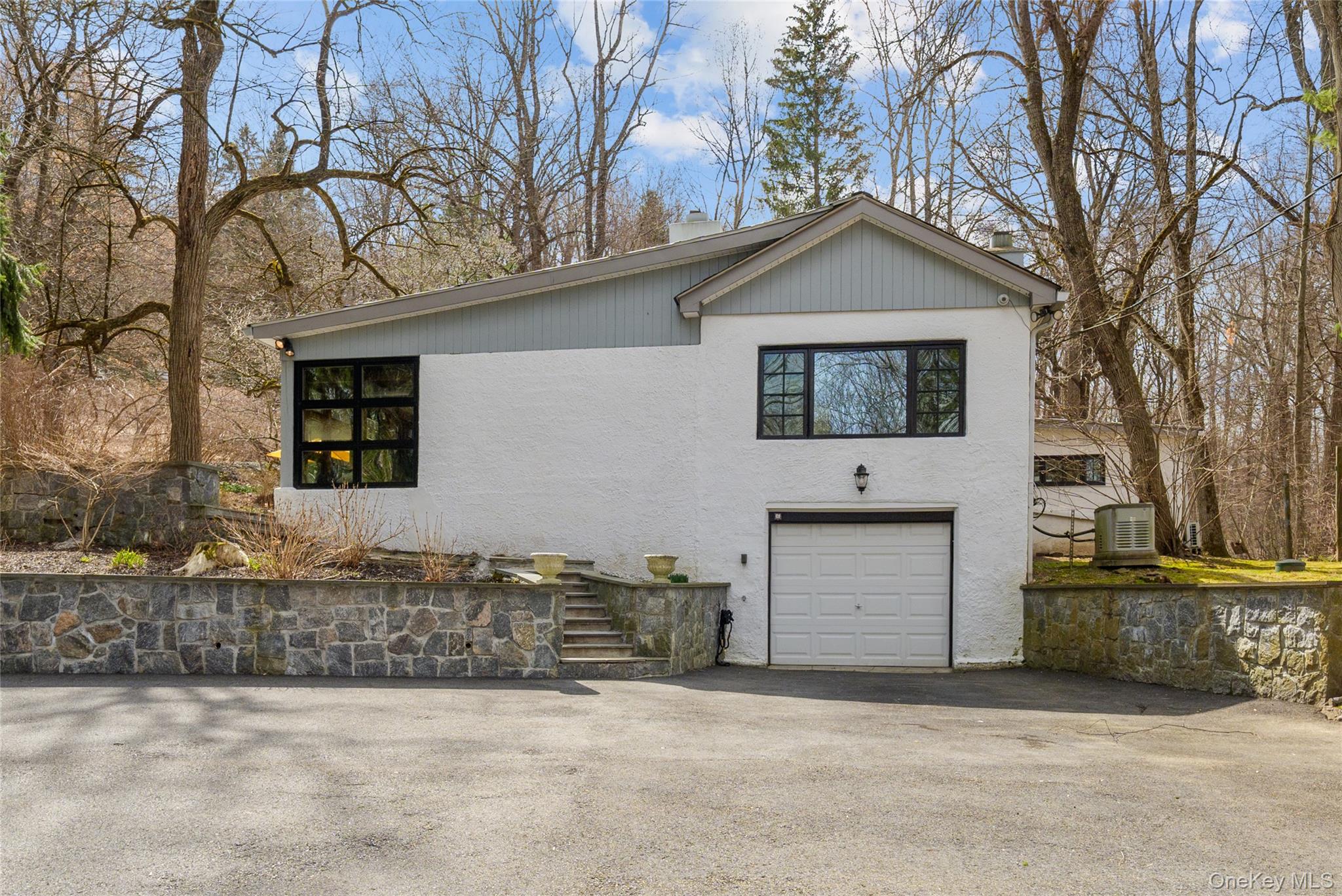 241 West Mt Airy Road Croton-on-Hudson, NY 10520 - Photo 3 of 41 a front view of a house with a yard and garage