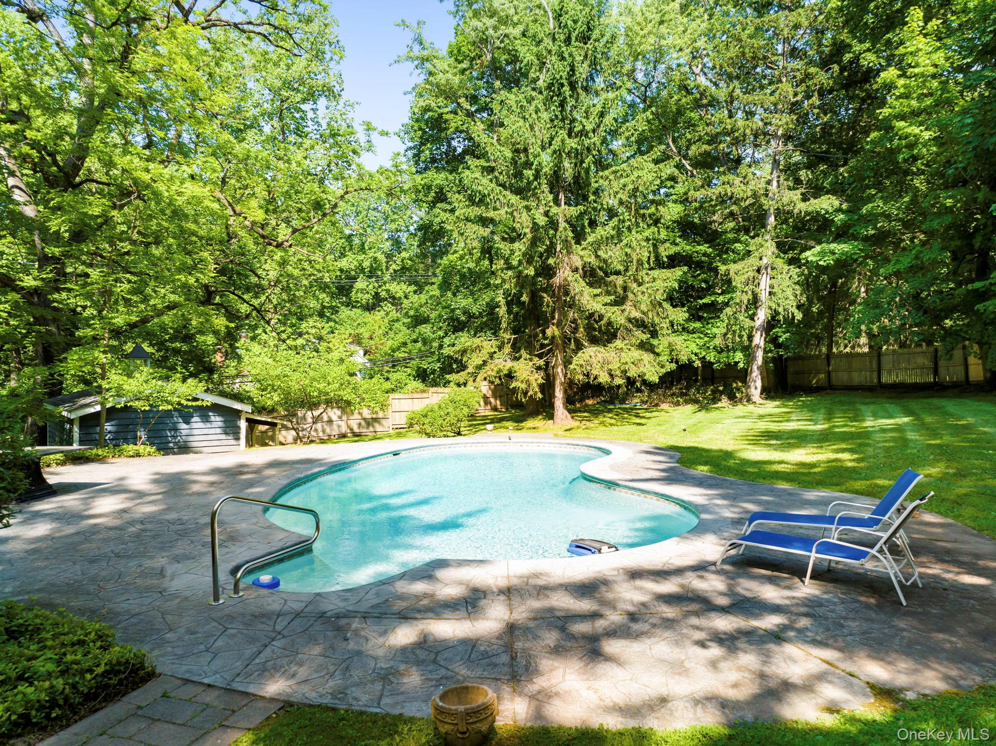 241 West Mt Airy Road Croton-on-Hudson, NY 10520 - Photo 5 of 41 a view of a swimming pool with lawn chairs under an umbrella