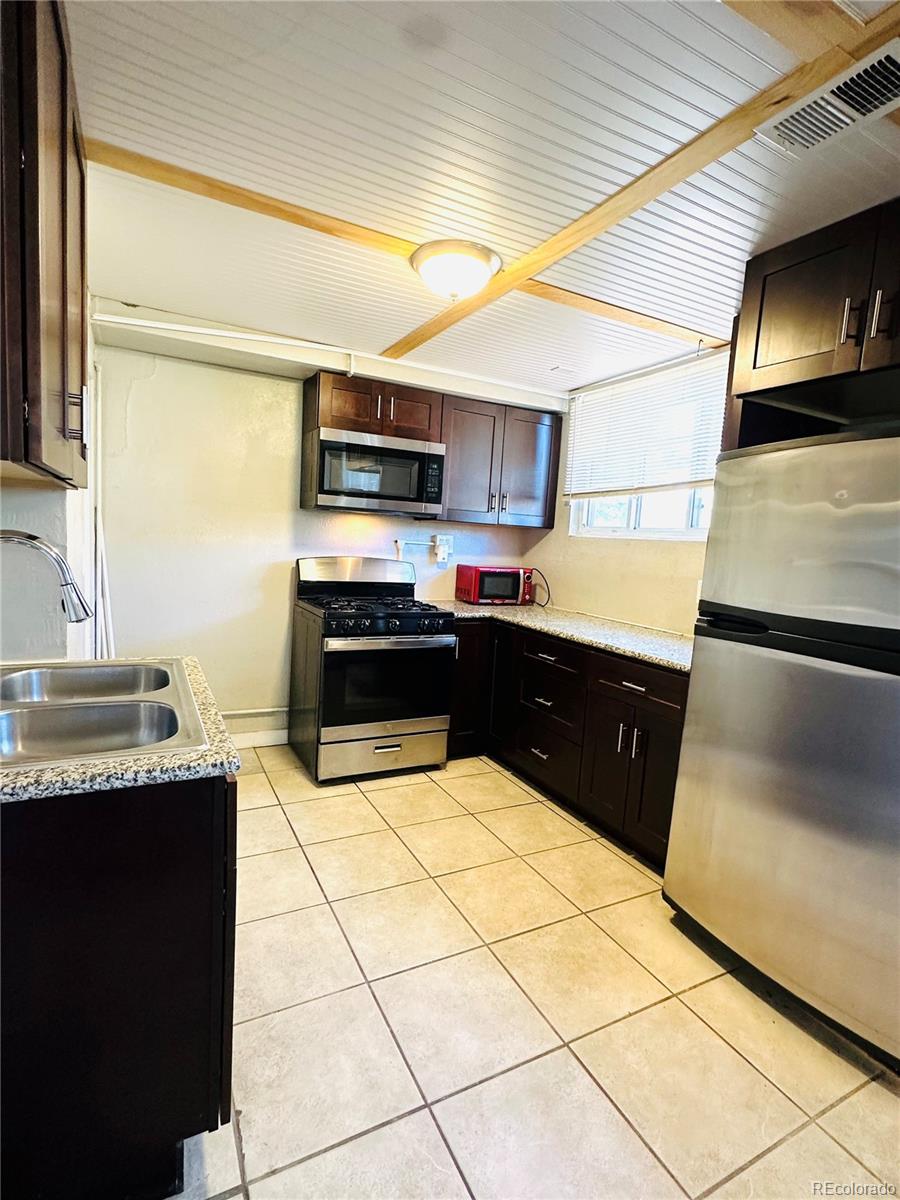1400 South Clermont Street, Unit 9 Denver, CO 80222 - Photo 5 of 9 a kitchen with stainless steel appliances granite countertop a sink and a stove