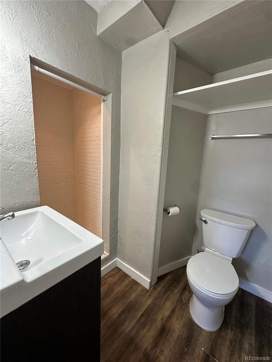 1400 South Clermont Street, Unit 9 Denver, CO 80222 - Photo 6 of 9 a white toilet sitting next to a bathroom sink
