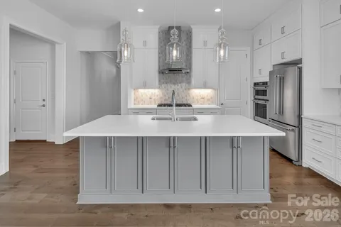 a kitchen with stainless steel appliances a refrigerator and cabinets