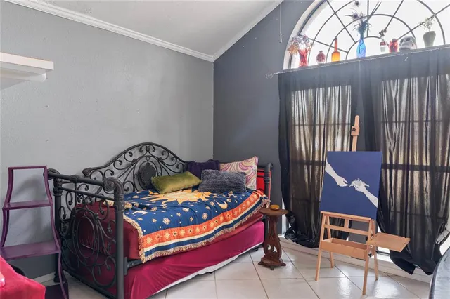 a bedroom with a bed and a painting on the wall