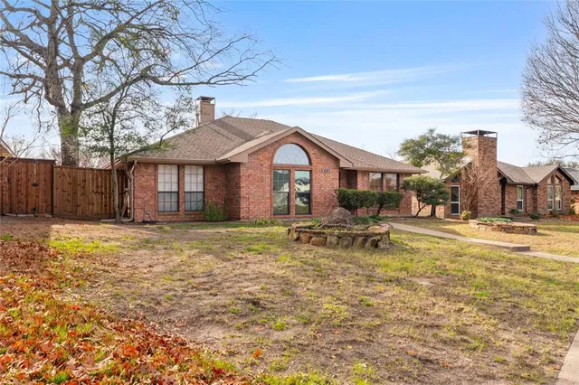 a backyard of a house with table and chairs