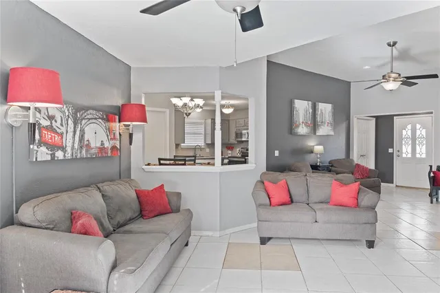 a living room with furniture and kitchen view