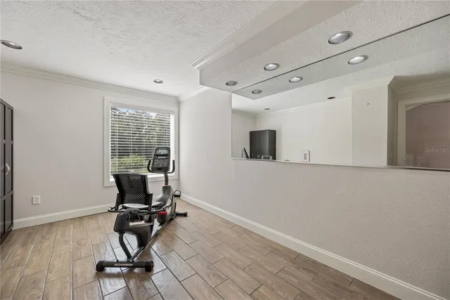 a view of an empty room with window and cabinet